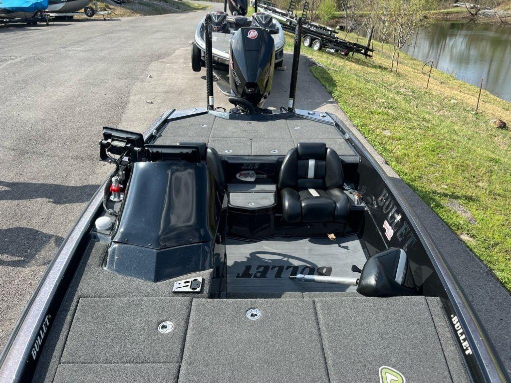 2022 Bullet 21XRS boat with sleek design, parked near a river.