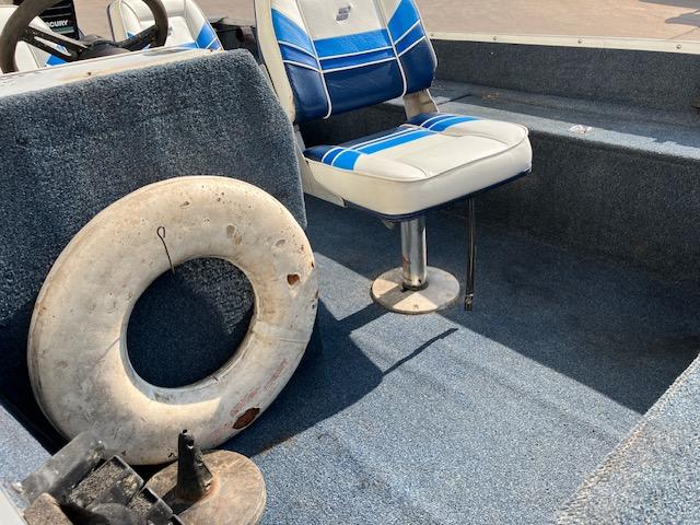 1992 Starcraft FM 160C boat interior with blue seats and life preserver.