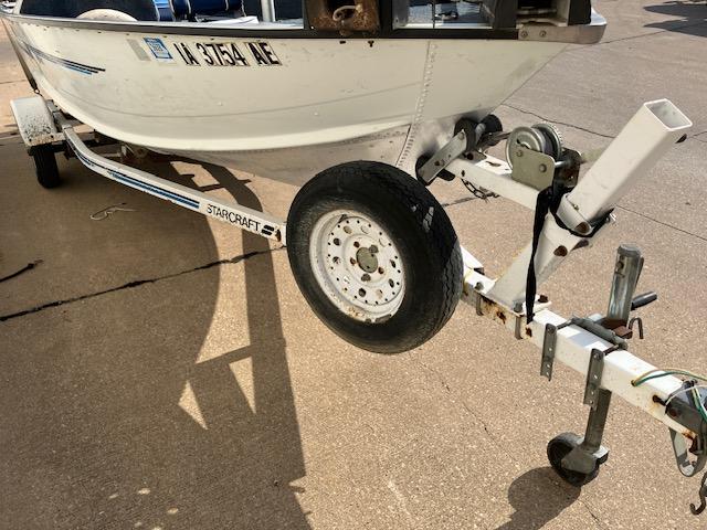 1992 Starcraft FM 160C boat on trailer, close-up of wheel and hitch.