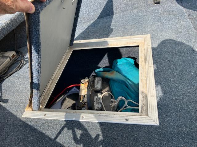 Boat storage compartment with battery in 1992 Starcraft FM 160C.