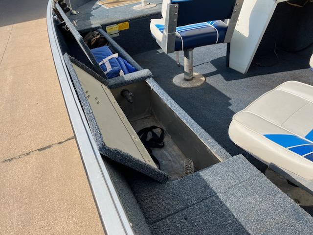 1992 Starcraft FM 160C boat interior with open storage compartments and blue seats.