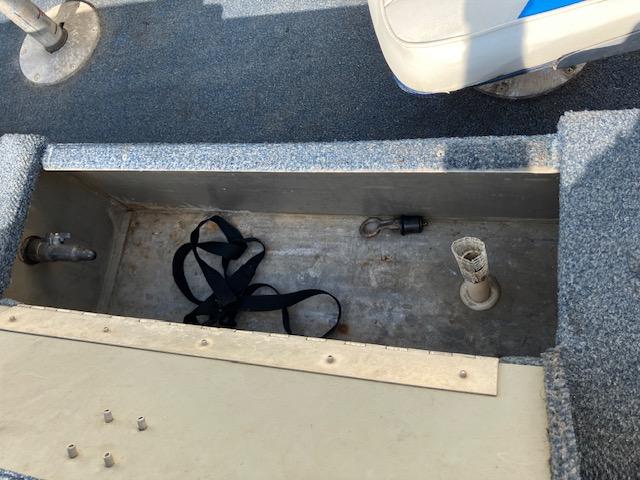 Open storage compartment in 1992 Starcraft FM 160C boat with straps and fittings.