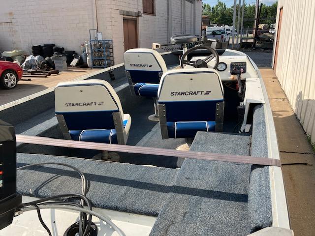1992 Starcraft FM 160C boat interior with blue and white seating, parked outdoors.