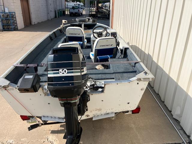 1992 Starcraft FM 160C boat with 50 HP outboard motor, parked outdoors.