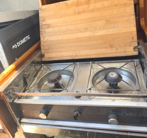 1979 Lancer Sloop stove with two burners and wooden cover.