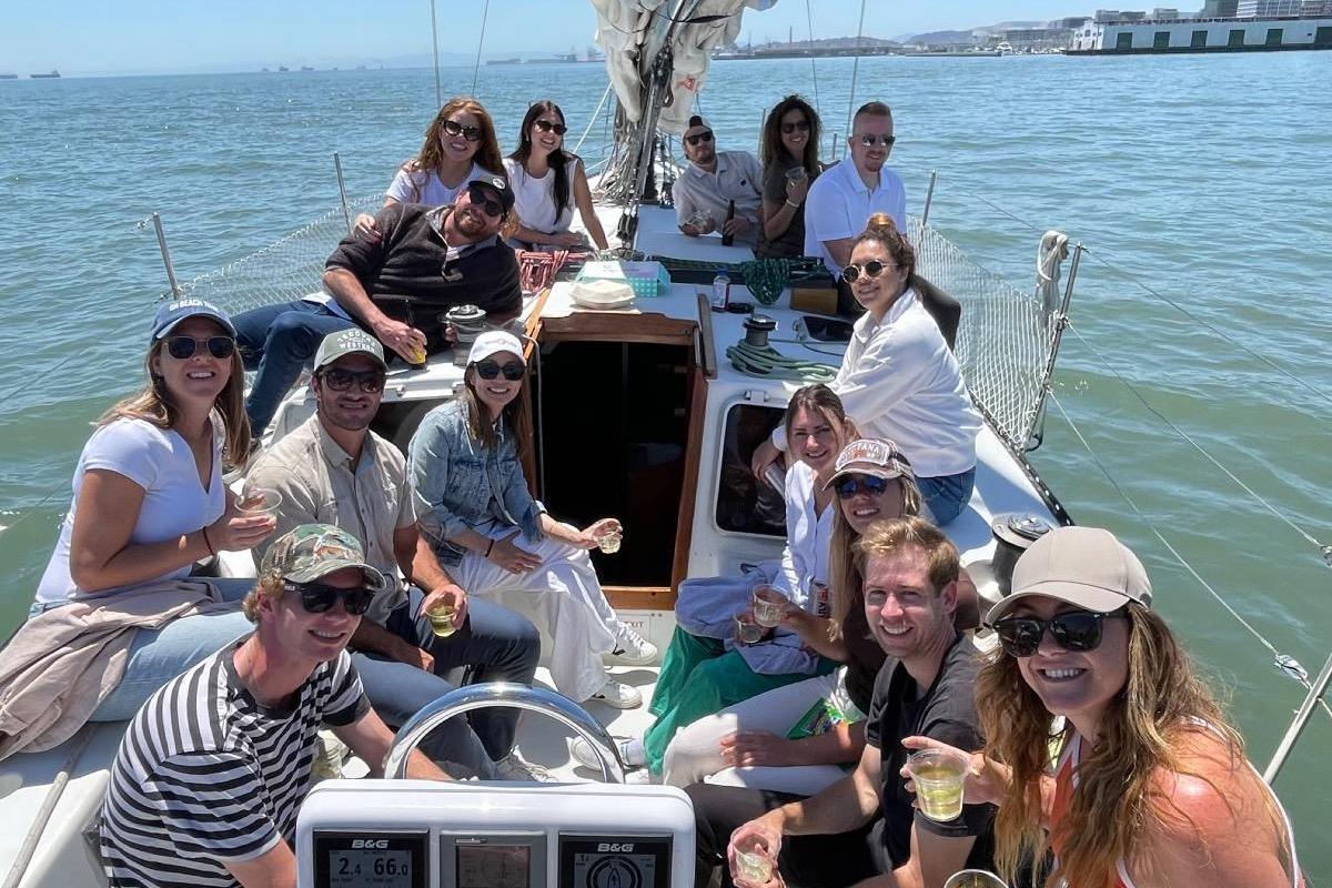 Group enjoying a sunny day on a 1982 Santa Cruz 50 sailboat.