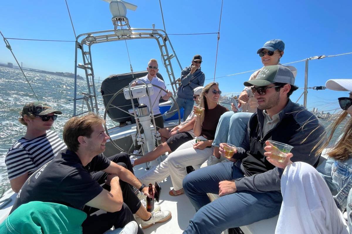 Group enjoying a sunny day on a 1982 Santa Cruz 50 sailboat.