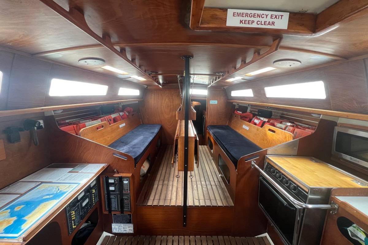 Interior of a 1982 Santa Cruz 50 sailboat with wooden furnishings and navigation equipment.