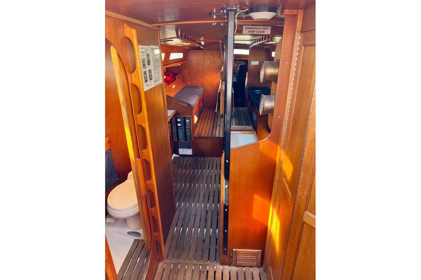 Interior of 1982 Santa Cruz 50 sailboat with wooden finishes and compact design.