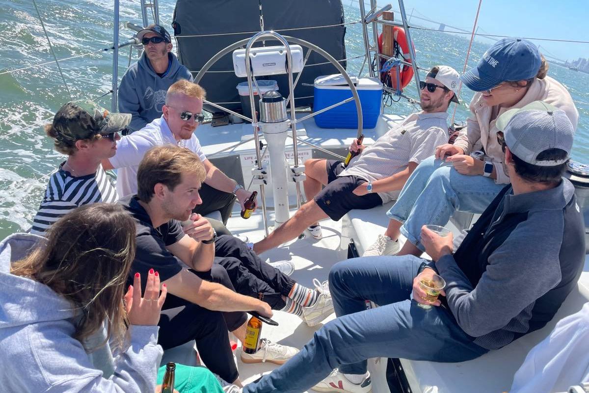 Group enjoying a sunny day on a 1982 Santa Cruz 50 sailboat.