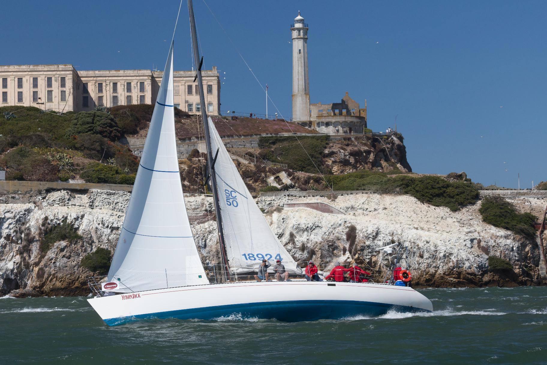 Sailboat Santa Cruz 50 (1982) cruising near Alcatraz Island with lighthouse in background.
