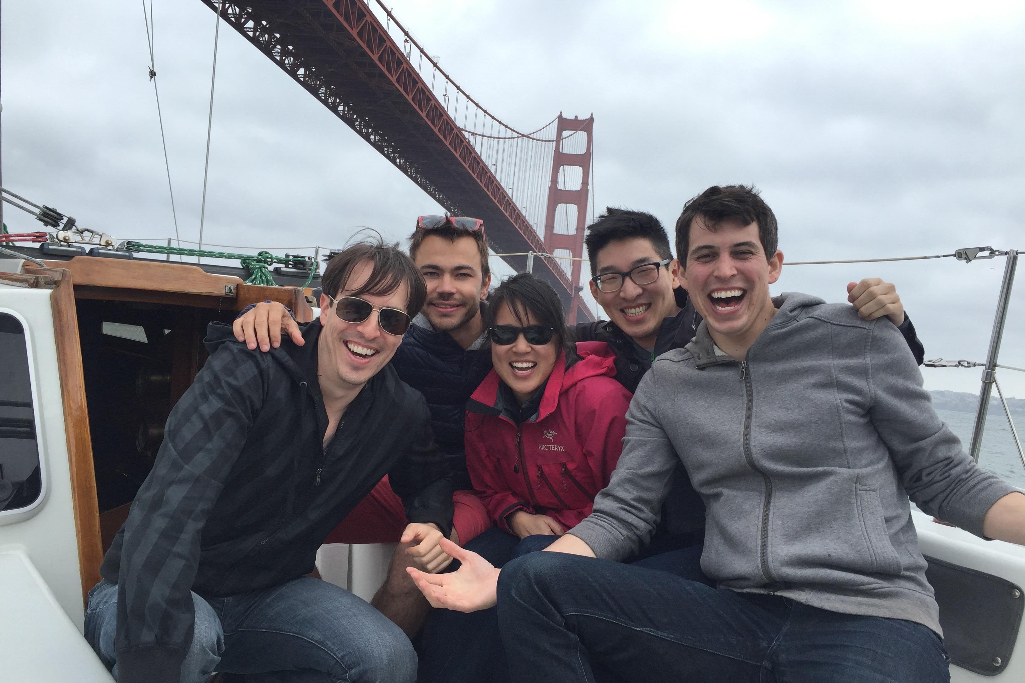 Group of friends smiling on a boat near the Golden Gate Bridge, 1982 Santa Cruz 50.