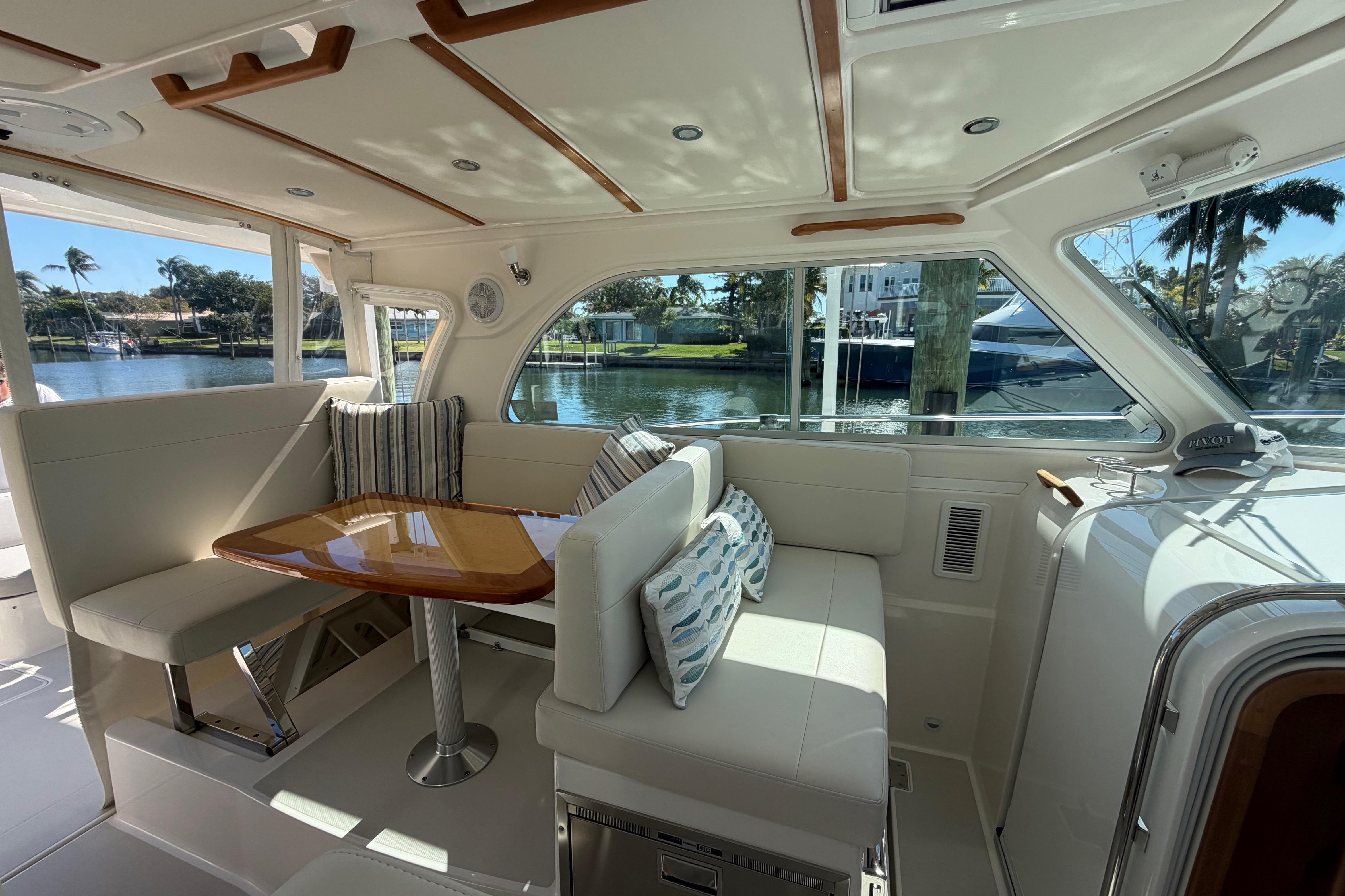 Luxurious interior of 2023 Back Cove 340 yacht with elegant seating and waterfront view.