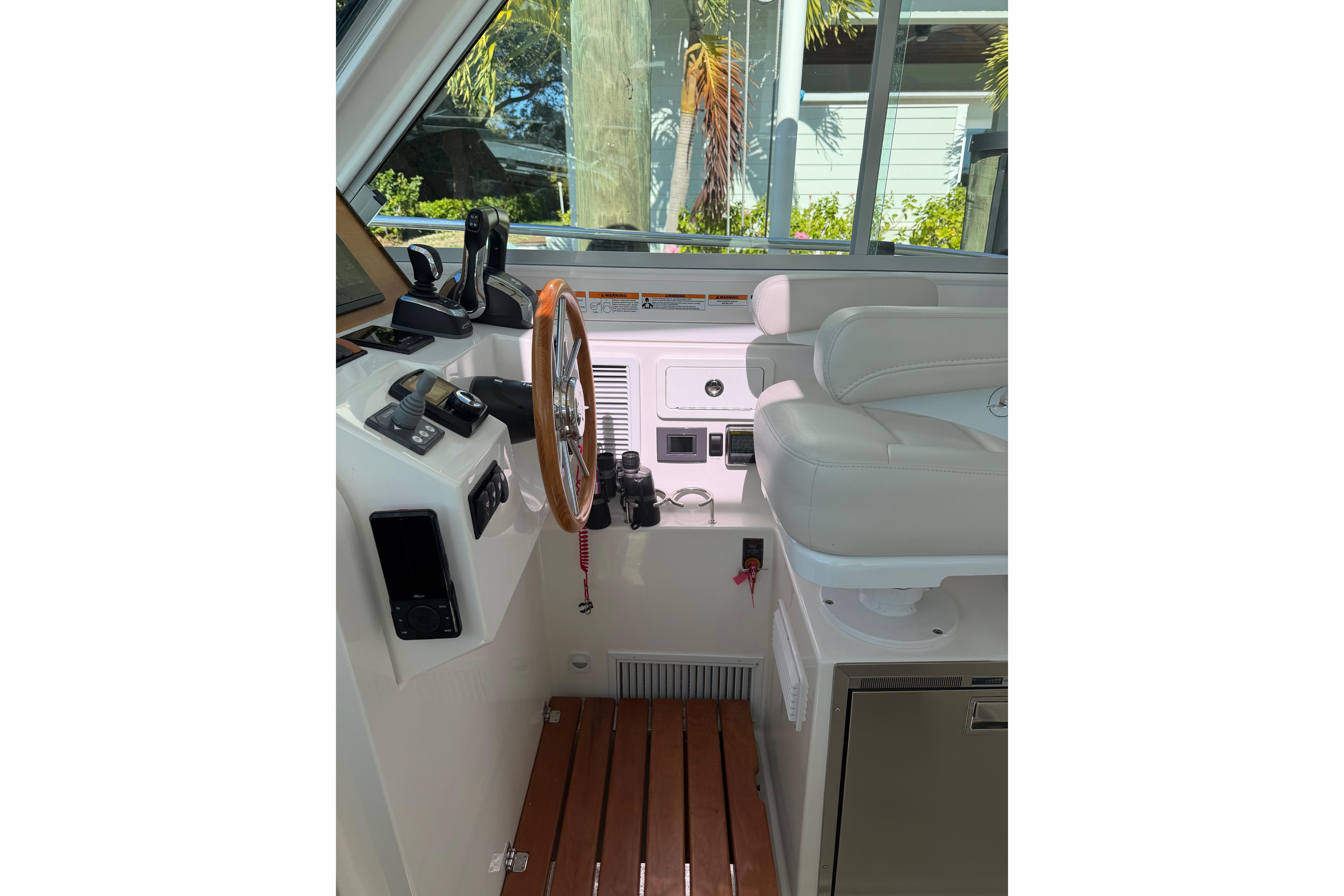 2023 Back Cove 340 helm with wooden steering wheel and modern controls.