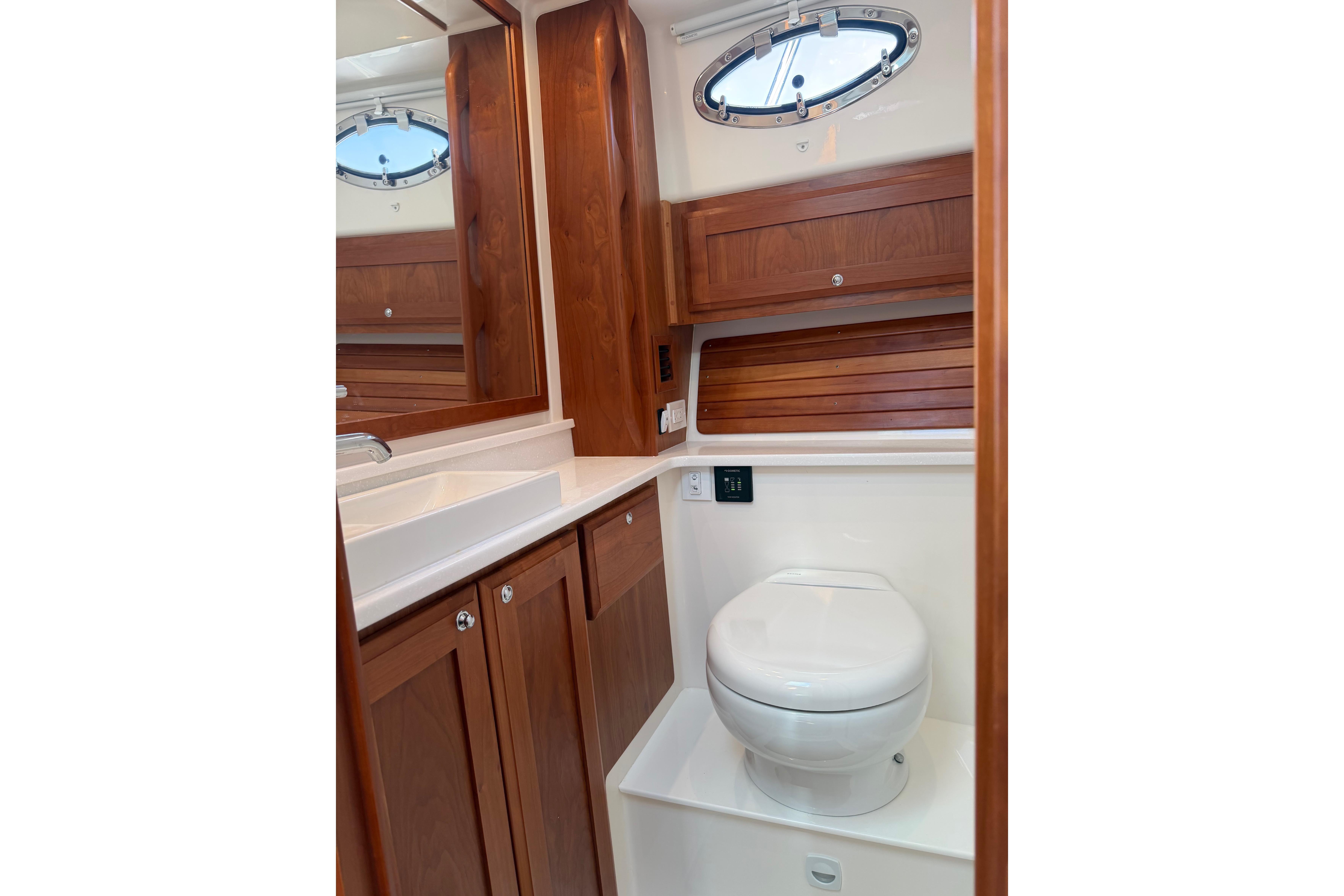 2023 Back Cove 340 yacht bathroom with wooden cabinetry and modern fixtures.