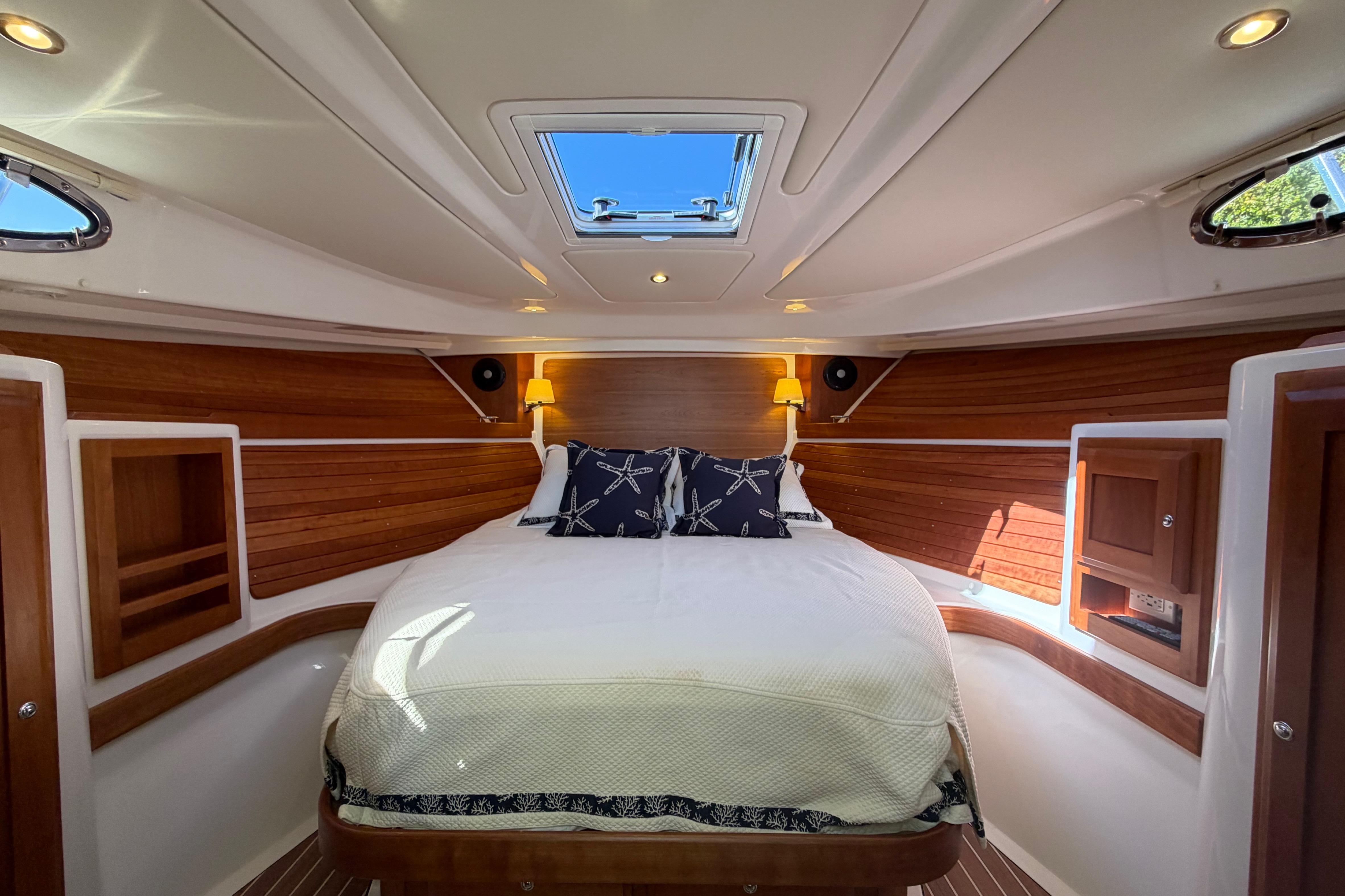 Luxurious cabin interior of 2023 Back Cove 340 yacht with elegant wood paneling.