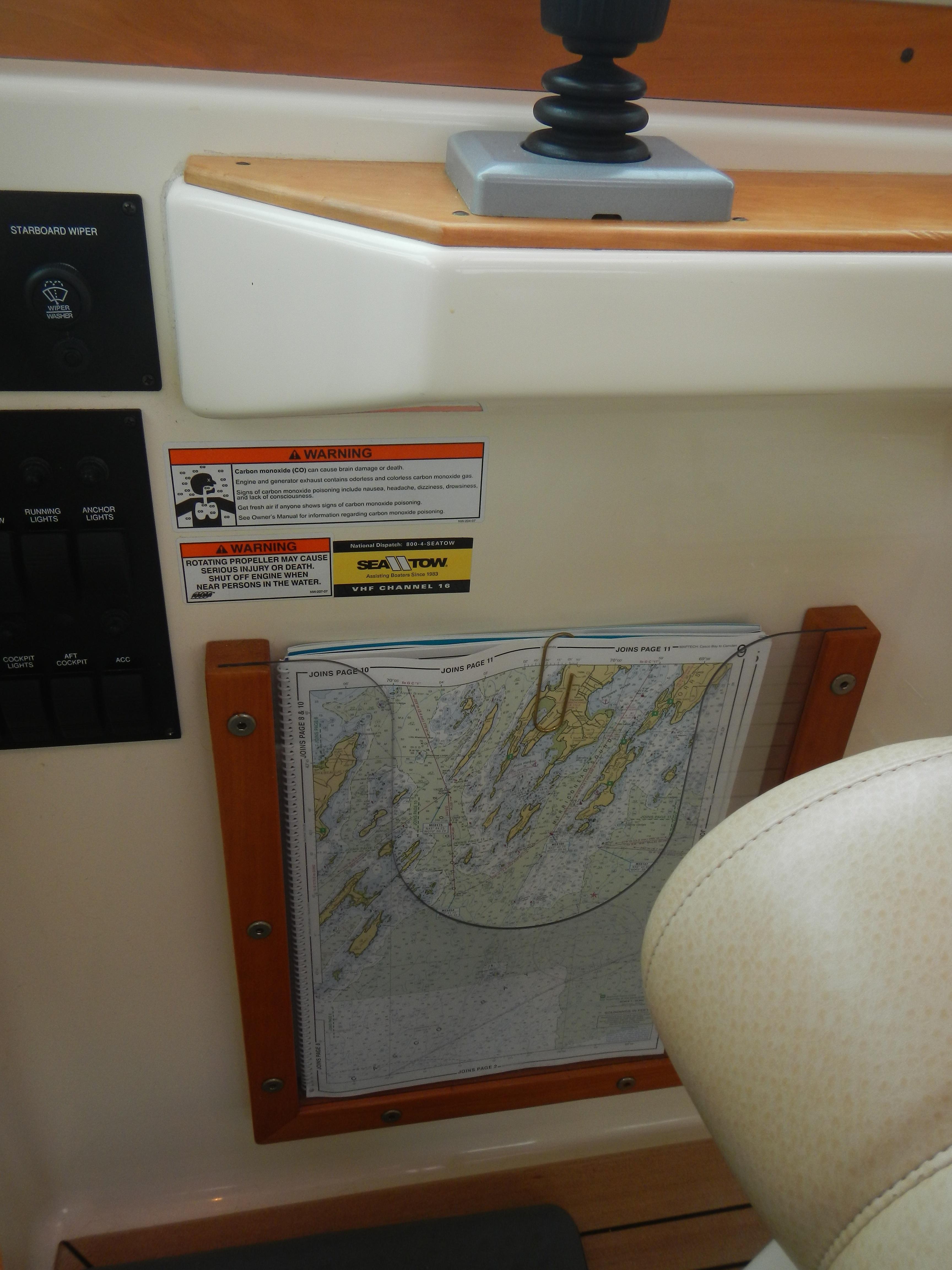 Custom chart holder to starboard of helm chair