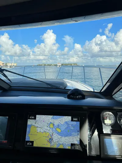 Seven Yacht Photos Pics View from 2018 Princess V58 yacht cockpit with navigation display, open sea, and blue sky.