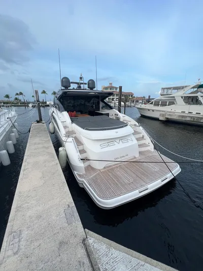 Seven Yacht Photos Pics Luxury 2018 Princess V58 yacht docked at marina, rear view.