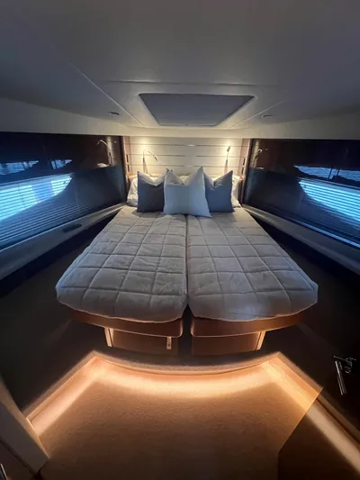 Seven Yacht Photos Pics Luxurious bedroom interior of 2018 Princess V58 yacht with elegant bedding and ambient lighting.