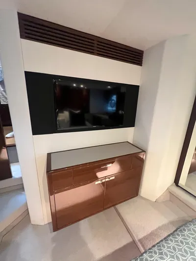 Seven Yacht Photos Pics 2018 Princess V58 yacht interior with TV and wooden cabinet.
