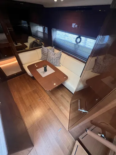 Seven Yacht Photos Pics Luxurious interior of 2018 Princess V58 yacht with elegant seating and wooden finishes.