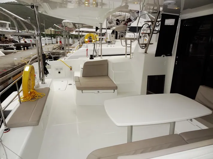Blind Ambition II Yacht Photos Pics Lagoon 42 catamaran 2020 model, spacious deck with seating and table, docked at marina.