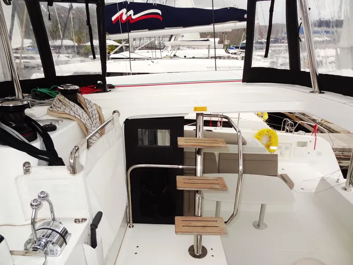 Blind Ambition II Yacht Photos Pics Interior view of 2020 Lagoon 42 catamaran with wooden steps and sailing equipment.