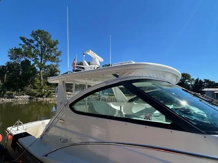 Absolutely Yacht Photos Pics 2006 Tiara Yachts Open boat docked by a serene lakeside under clear blue skies.