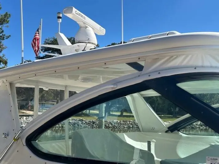 Absolutely Yacht Photos Pics 2006 Tiara Yachts Open with Garmin radar, American flag, and sleek design.