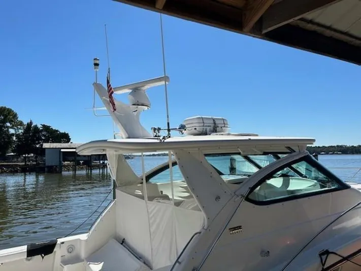 Absolutely Yacht Photos Pics 2006 Tiara Yachts Open docked by a serene waterfront under clear blue skies.