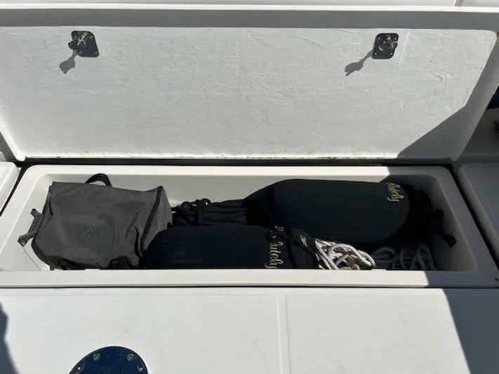 Absolutely Yacht Photos Pics Storage compartment on a 2006 Tiara Yachts Open, containing boating gear and accessories.