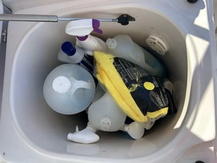 Absolutely Yacht Photos Pics Storage compartment on a 2006 Tiara Yachts Open, filled with cleaning supplies.
