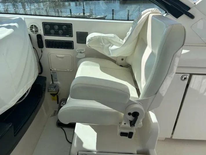 Absolutely Yacht Photos Pics Captain's seat on a 2006 Tiara Yachts Open, featuring control panel and white upholstery.