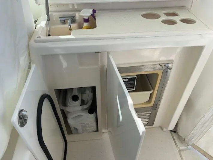 Absolutely Yacht Photos Pics 2006 Tiara Yachts Open interior with storage compartments and cleaning supplies.