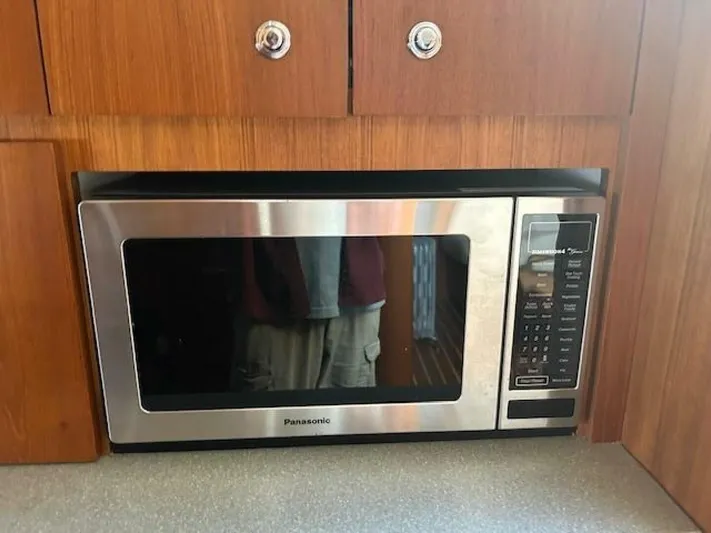 Absolutely Yacht Photos Pics Built-in Panasonic microwave in 2006 Tiara Yachts Open, set in wooden cabinetry.