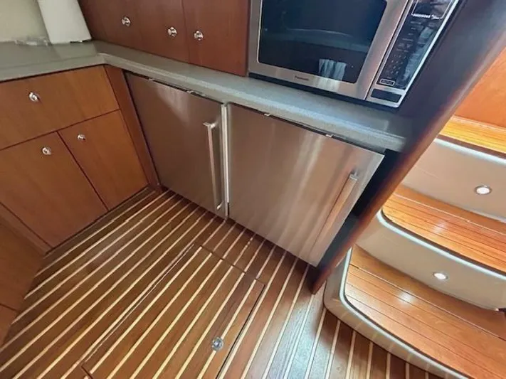 Absolutely Yacht Photos Pics 2006 Tiara Yachts Open kitchen with wood flooring, stainless appliances, and modern cabinetry.