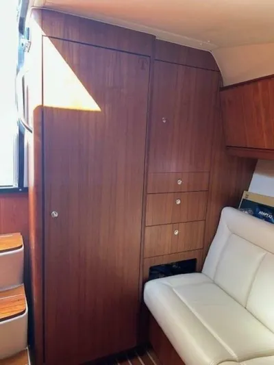 Absolutely Yacht Photos Pics 2006 Tiara Yachts Open interior with wooden cabinetry and white seating.