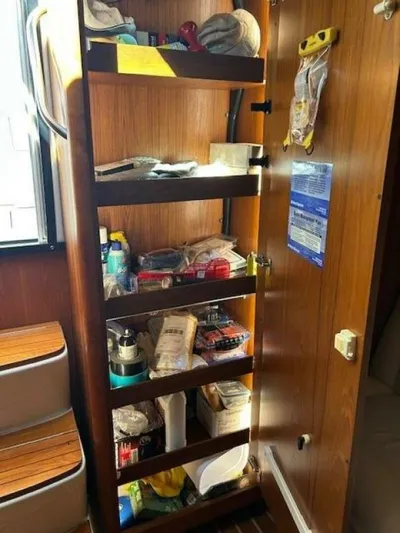 Absolutely Yacht Photos Pics 2006 Tiara Yachts Open interior with wooden shelves and various stored items.