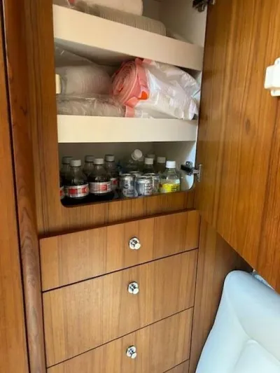 Absolutely Yacht Photos Pics Wooden cabinet with shelves and drawers in a 2006 Tiara Yachts Open.