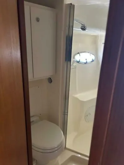Absolutely Yacht Photos Pics 2006 Tiara Yachts Open bathroom with shower, toilet, and storage cabinet.