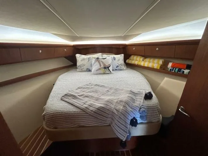 Absolutely Yacht Photos Pics 2006 Tiara Yachts Open cabin interior with cozy bed and wooden accents.
