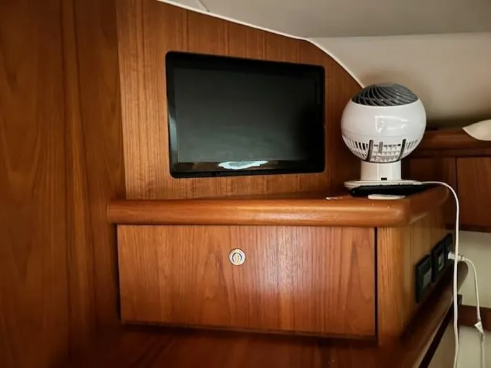 Absolutely Yacht Photos Pics 2006 Tiara Yachts Open interior with wooden cabinetry and small TV screen.