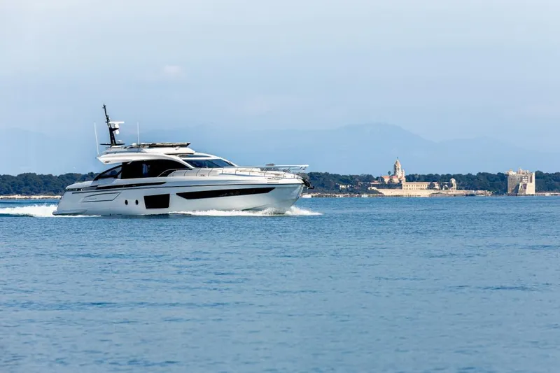  Yacht Photos Pics 2023 Azimut S8 yacht cruising on open water with scenic coastal backdrop.