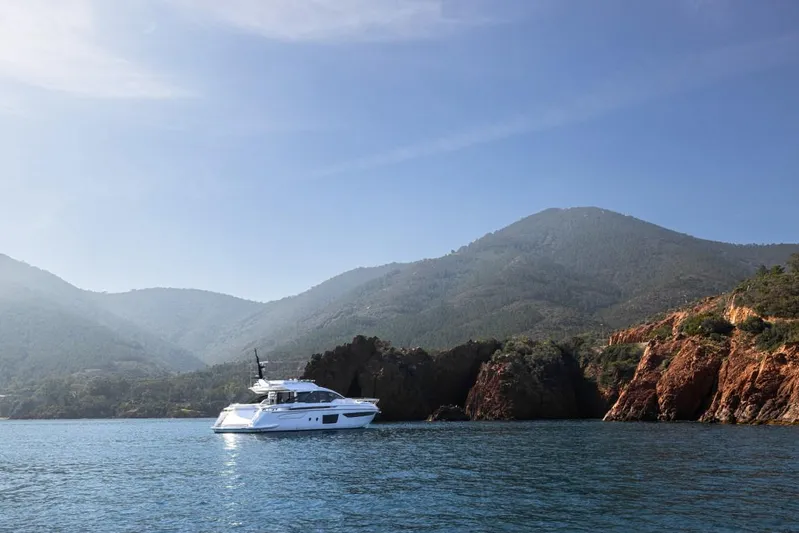  Yacht Photos Pics 2023 Azimut S8 yacht cruising near scenic coastal mountains.