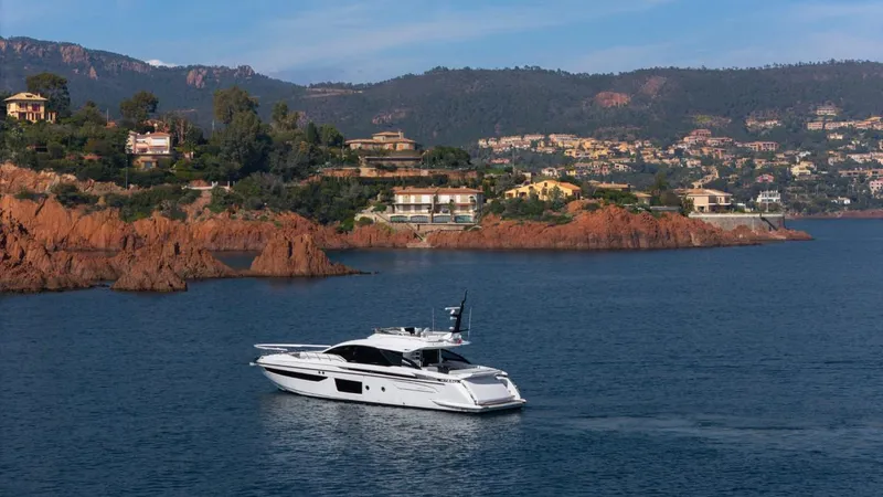  Yacht Photos Pics 2023 Azimut S8 yacht cruising near scenic coastal cliffs and luxury homes.