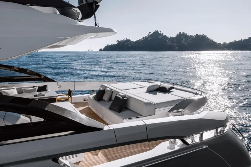  Yacht Photos Pics Luxurious 2023 Azimut S8 yacht with elegant deck, ocean view, and island backdrop.