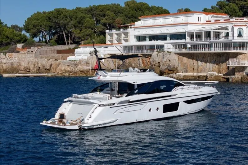  Yacht Photos Pics 2023 Azimut S8 yacht cruising near a luxurious coastal villa.
