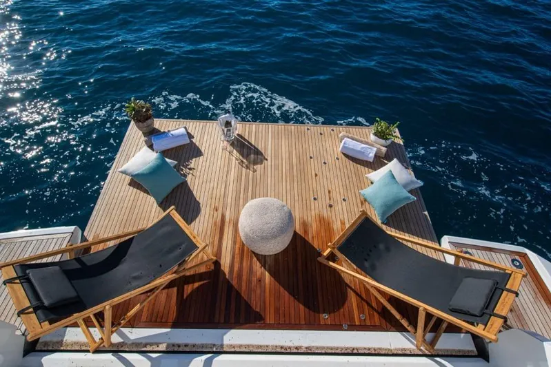  Yacht Photos Pics Luxurious 2023 Azimut S8 yacht deck with chairs, cushions, and ocean view.