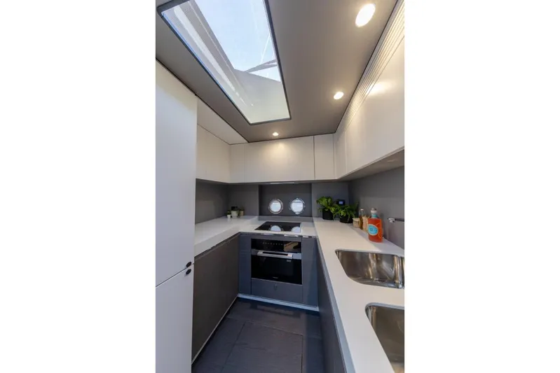  Yacht Photos Pics Modern kitchen interior of 2023 Azimut S8 yacht with sleek design and skylight.
